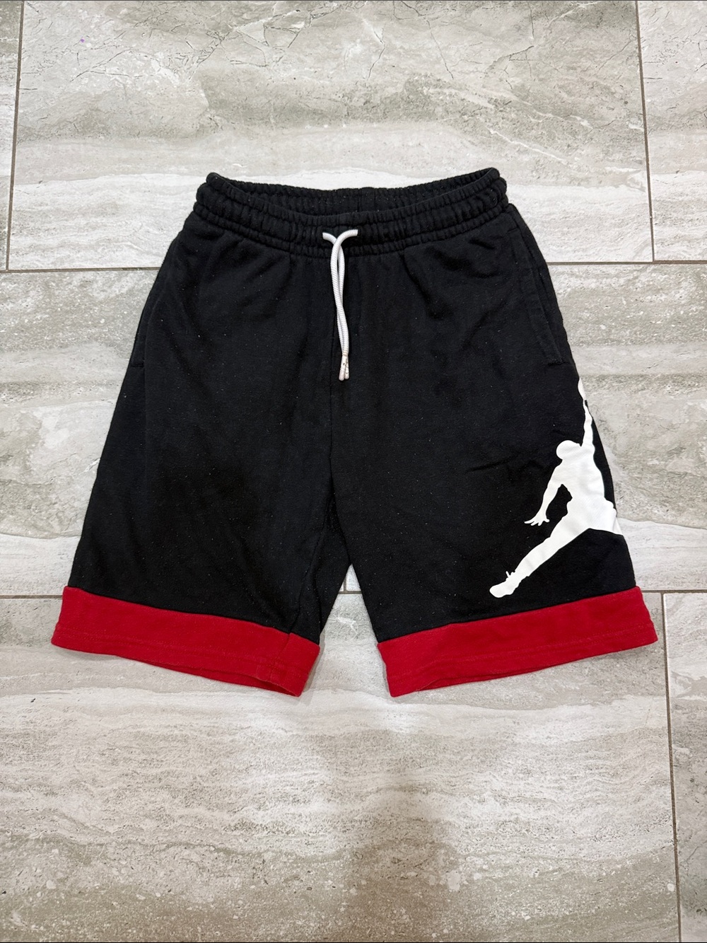 Nike Black Men's Athletic Shorts with Red Hem and White Silhouette